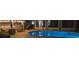 The outdoor pool is brightly lit at night with covered seating area at 10404 Crestfield Dr, Riverview, FL 33569