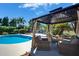 Lovely outdoor space with a refreshing pool and shaded lounge area perfect for entertaining or relaxing at 10404 Crestfield Dr, Riverview, FL 33569