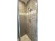 Modern shower with gray subway tile, contrasting decorative accent, and a stylish shower head at 10404 Crestfield Dr, Riverview, FL 33569