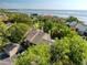 An aerial view of a home featuring lush trees, and water views at 1111 N Bayshore Blvd # E3, Clearwater, FL 33759