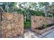 Backyard with a paver patio and a rock wall providing privacy at 1111 N Bayshore Blvd # E3, Clearwater, FL 33759