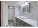 Stylish bathroom featuring gray cabinets, a marble countertop, and a vessel sink at 1111 N Bayshore Blvd # E3, Clearwater, FL 33759