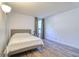 Bedroom featuring a queen-sized bed, hardwood floors, and a window with neutral curtains at 1111 N Bayshore Blvd # E3, Clearwater, FL 33759