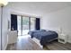 Cozy bedroom features two beds, a work desk, and a large window with natural light at 1111 N Bayshore Blvd # E3, Clearwater, FL 33759