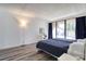 Bright bedroom with two twin beds, a desk, and sliding glass doors opening to the outside at 1111 N Bayshore Blvd # E3, Clearwater, FL 33759