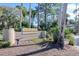Well-maintained community sign surrounded by lush landscaping, creating a welcoming entrance to Sunfish Bay at 1111 N Bayshore Blvd # E3, Clearwater, FL 33759