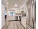 Contemporary kitchen with stainless appliances, white cabinetry and a view to the living area at 1111 N Bayshore Blvd # E3, Clearwater, FL 33759