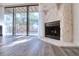 Bright living room with a stone fireplace and sliding glass doors leading to a private patio at 1111 N Bayshore Blvd # E3, Clearwater, FL 33759