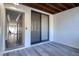 This screened in patio boasts wood-look plank flooring and view of a hallway at 1111 N Bayshore Blvd # E3, Clearwater, FL 33759