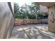 Private outdoor patio with stone wall and mature trees creating a serene, private setting at 1111 N Bayshore Blvd # E3, Clearwater, FL 33759