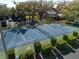 Community tennis court surrounded by manicured greenery, offering a great space for recreation and exercise at 1111 N Bayshore Blvd # E3, Clearwater, FL 33759
