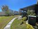 Landscaped backyard featuring a stone pathway and a screened-in patio, ideal for relaxation at 11193 Spring Point Cir, Riverview, FL 33579