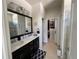 Bathroom featuring a double sink vanity, walk-in closet access, and a well-lit, modern design at 11193 Spring Point Cir, Riverview, FL 33579