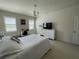 Bedroom featuring tile floors, a white bed, a work desk, and neutral-toned walls with a view from the bed at 11193 Spring Point Cir, Riverview, FL 33579