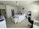 Comfortable bedroom with a white bed, tile floors, and a desk, offering a serene and functional space at 11193 Spring Point Cir, Riverview, FL 33579