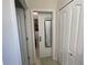 Hallway that provides access to the walk-in closet, featuring a mirror and built-in storage, enhancing accessibility at 11193 Spring Point Cir, Riverview, FL 33579