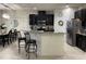Kitchen featuring dark cabinetry, stainless steel appliances, and bar stool seating at the island at 11193 Spring Point Cir, Riverview, FL 33579