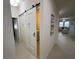Hallway view of laundry room with sliding barn door at 11193 Spring Point Cir, Riverview, FL 33579