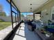 Relaxing screened patio with a grill, rocking chairs, and stylish outdoor furniture at 11193 Spring Point Cir, Riverview, FL 33579