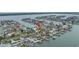 Aerial view of the home in a waterfront community with boat docks and stunning water views at 11755 7Th E St, Treasure Island, FL 33706