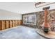 Stone wall with a large picture window and modern copper fireplace at 11755 7Th E St, Treasure Island, FL 33706