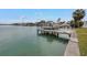 View of boat on a lift from the backyard, showing waterfront access at 11755 7Th E St, Treasure Island, FL 33706