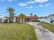 Single Gathering home with stone facade, red tile roof, and a curved driveway at 11755 7Th E St, Treasure Island, FL 33706