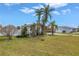 Attractive single-story home boasting stone detailing, lush greenery, and well-kept landscaping on a bright, sunny day at 11755 7Th E St, Treasure Island, FL 33706