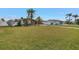 Manicured front yard showcasing a single-story home with stone accents, mature trees, and a well-maintained lawn at 11755 7Th E St, Treasure Island, FL 33706