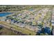 An aerial view of a community, showcasing well-maintained homes and landscaping with a scenic pond at 12639 Lemon Pepper Dr, Riverview, FL 33578