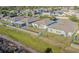 Aerial view of a fenced backyard with a well-maintained lawn and trees at 12639 Lemon Pepper Dr, Riverview, FL 33578