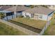 An enclosed backyard featuring a well-maintained lawn, patio furniture, and privacy fence at 12639 Lemon Pepper Dr, Riverview, FL 33578