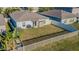 Aerial shot of fenced backyard with healthy lawn and patio with grill and storage shed at 12639 Lemon Pepper Dr, Riverview, FL 33578