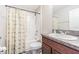Bright bathroom featuring a tub shower with a patterned curtain and a sink with granite countertop at 12639 Lemon Pepper Dr, Riverview, FL 33578