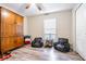 Bedroom with a ceiling fan, wood-look flooring, a large wooden armoire, and two black beanbag chairs at 12639 Lemon Pepper Dr, Riverview, FL 33578
