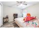Bedroom with a ceiling fan, wood-look flooring, TV on stand and bed with a floral comforter at 12639 Lemon Pepper Dr, Riverview, FL 33578