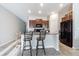 Kitchen island with granite countertops and a breakfast bar that offers additional seating at 12639 Lemon Pepper Dr, Riverview, FL 33578