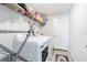 Well-organized laundry room includes a washer, dryer, and ample shelving for storage at 12639 Lemon Pepper Dr, Riverview, FL 33578