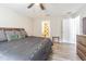 Spacious bedroom with a dark gray bed set, ceiling fan, and an en-suite bathroom at 12639 Lemon Pepper Dr, Riverview, FL 33578