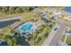 Aerial view of the community pool area, featuring ample seating, palm trees and well maintained landscaping at 12639 Lemon Pepper Dr, Riverview, FL 33578