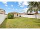 Expansive backyard with manicured lawn, privacy fence, and partial view of the rear of the home at 14426 Haddon Mist Dr, Wimauma, FL 33598