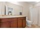 Clean bathroom features a light-colored vanity, neutral walls, a toilet, and a bathtub with shower at 14426 Haddon Mist Dr, Wimauma, FL 33598