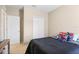 bedroom features tan walls and carpet, and a twin bed adorned with superhero dolls at 14426 Haddon Mist Dr, Wimauma, FL 33598