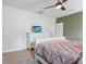 Comfortable bedroom featuring neutral carpet, a TV on a dresser, and soothing green accent wall at 14426 Haddon Mist Dr, Wimauma, FL 33598