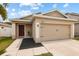 Charming single-story home featuring a two-car garage and well-maintained lawn in a desirable neighborhood at 14426 Haddon Mist Dr, Wimauma, FL 33598