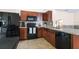 Modern kitchen with stainless steel appliances and granite countertops at 14426 Haddon Mist Dr, Wimauma, FL 33598