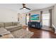 Comfortable living room featuring hardwood floors, television, and natural light at 14426 Haddon Mist Dr, Wimauma, FL 33598