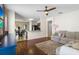 Cozy living room with hardwood floors, a ceiling fan, and comfortable seating at 14426 Haddon Mist Dr, Wimauma, FL 33598