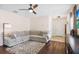Comfortable living room with hardwood floors, ceiling fan, and a sectional sofa at 14426 Haddon Mist Dr, Wimauma, FL 33598