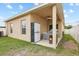 Covered patio with a ceiling fan, grill, outdoor storage, and view of the backyard at 14426 Haddon Mist Dr, Wimauma, FL 33598
